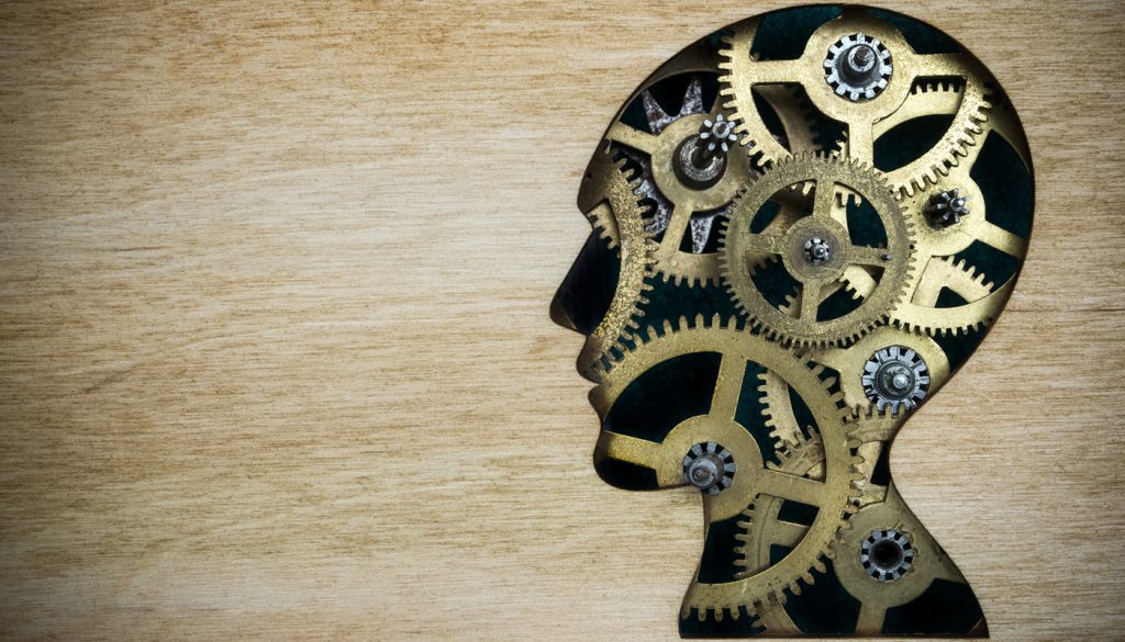 这是一个由生锈的金属齿轮制成的人头轮廓模型的插图