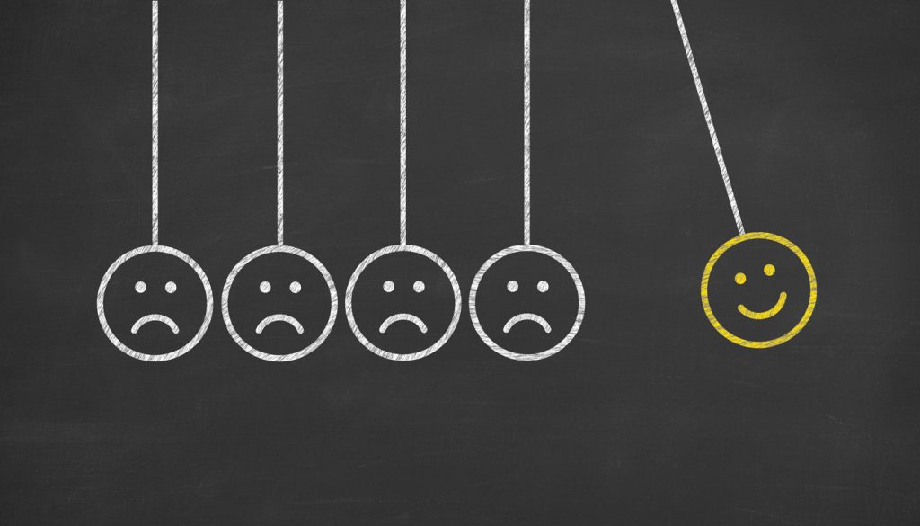 这是一张牛顿摇篮的插图，脸上有快乐的表情，也有悲伤的表情