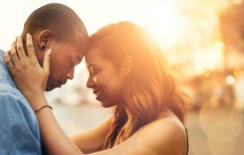 这是一对深情的年轻夫妇在户外分享温柔时刻的照片